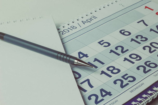 sheet of a calendar and a pen close-up - Photo, Image