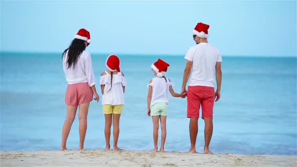 Happy family with two kids in Santa Hat on summer vacation celebrate Christmas - Footage, Video
