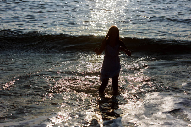 Pretty girl or beautiful happy little girl swimsuit running on sandy beach along sea or ocean shore, - Foto, Imagem