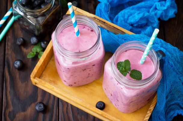 Mason jar mugs with fresh berry cocktails blueberry. The concept - Photo, Image