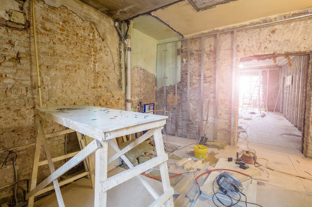 Wooden board in room and construction tools are in an apartment during on the construction, remodeling, rebuilding and renovation.  - Photo, image