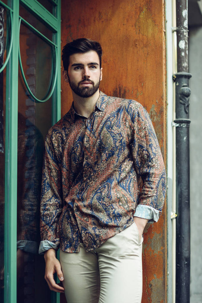 Young bearded man, model of fashion, wearing shirt in urban back - Fotografie, Obrázek