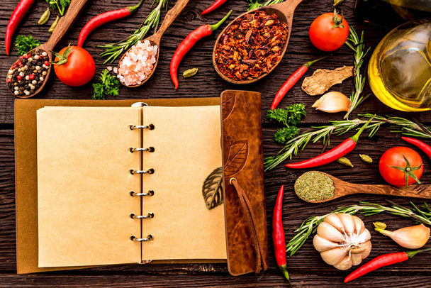 Open cook book and various spices composition - Photo, Image