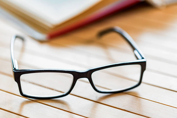 Glasses and open book on wooden table close - Foto, Imagem
