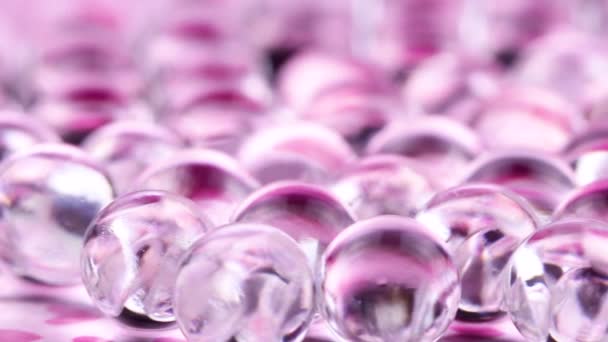 Violette en purpere water gel ballen. Macro opnamen, kan worden gebruikt voor reclame of cosmetica en geneeskunde. Abstracte achtergrond. - Video