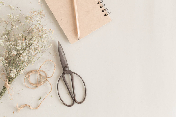 flat lay image with old scissors and notebook on paper background - Фото, изображение