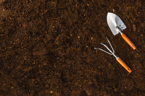 Gardening tools on garden soil texture background top view - Zdjęcie, obraz