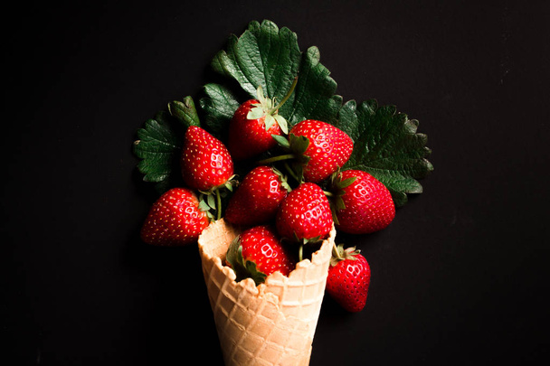 Fresh red strawberries on a black background - Valokuva, kuva