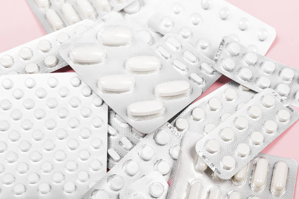 Various medicine pills on pink background - Photo, image