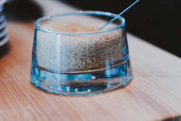 Brown sugar in spoon and dishware on napkin - Valokuva, kuva