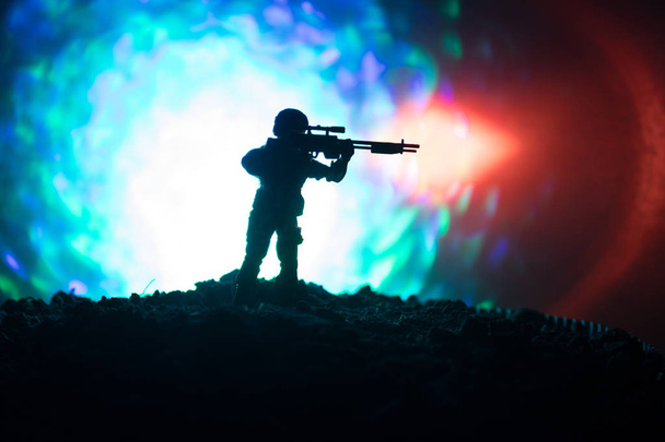 Army sniper with large-caliber sniper rifle seeking killing enemy. Silhouette on sky background. National security ensured, servicemen on guard - Photo, Image