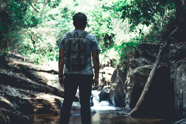 travel in the forest Man walking in natural water - Photo, Image