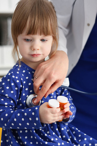 Little child with stethoscope at doctor reception - Foto, imagen