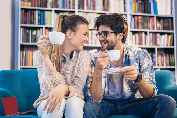 Couple drinking coffee and flirting indoor in cafe - Photo, Image