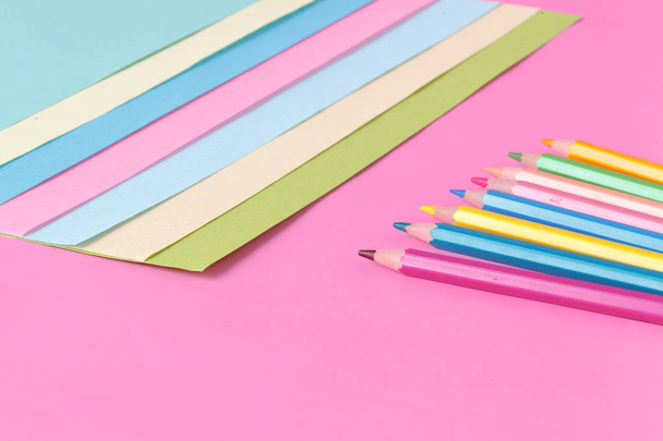 Color paper and pen on pink background, creative concept - Foto, afbeelding