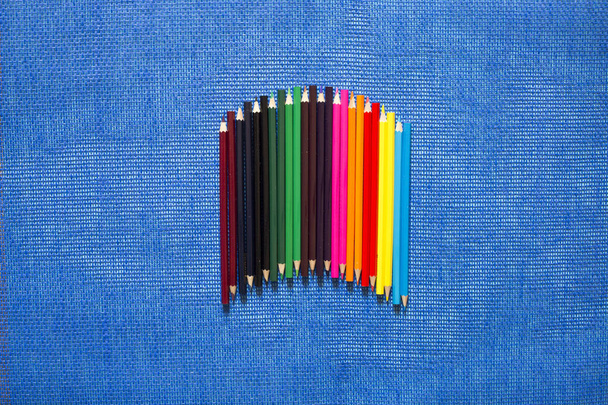 Set of colored pencils on a blue background - Fotó, kép