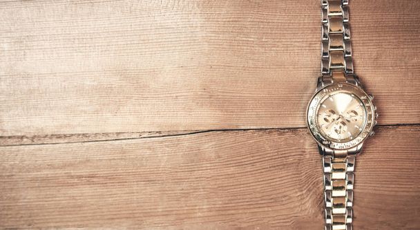 Wristwatch on a wood background. - Photo, Image