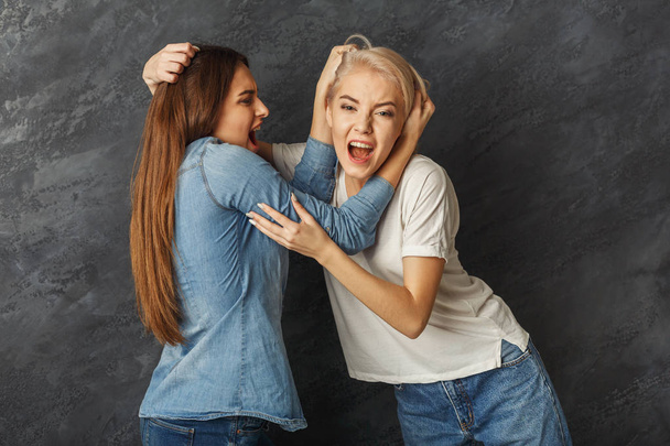 Two female friends having fun at studio background - Fotografie, Obrázek