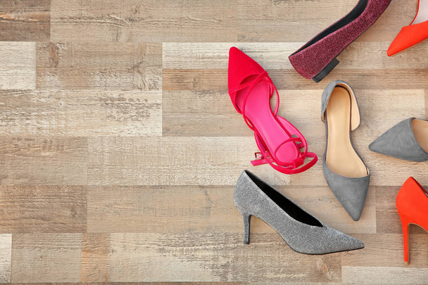 Different female shoes on floor, top view - Fotó, kép