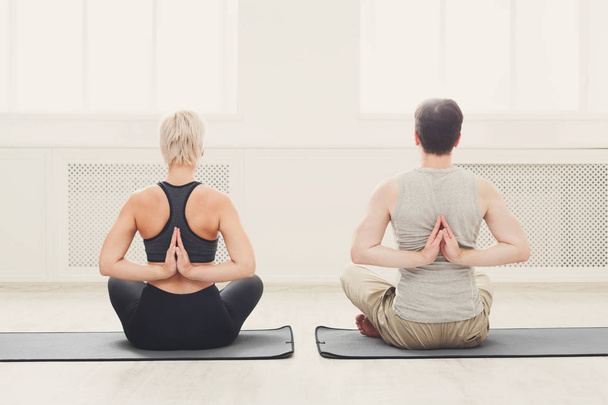 Young couple in yoga class, back stretching - Foto, Imagem