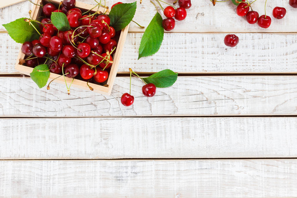 Ripe cherries on wooden table. View from above - Фото, изображение