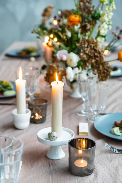 Easter table with candles. Decor - 写真・画像