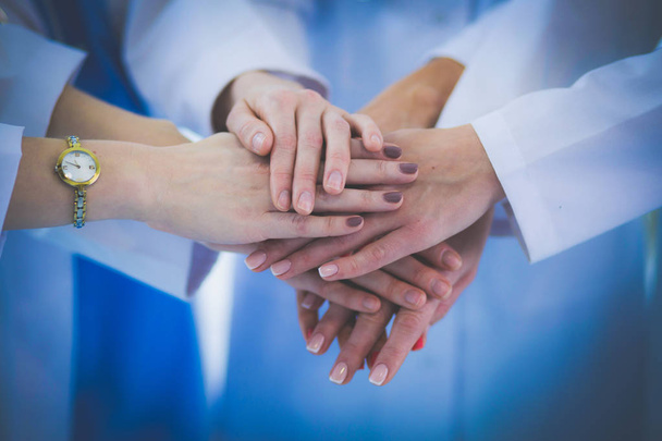 Doctors and nurses in a medical team stacking hands - Fotografie, Obrázek