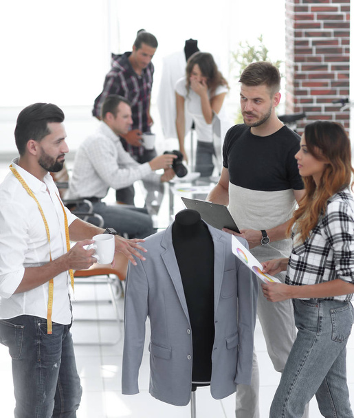 group of designers discuss mens suit - Foto, Imagem