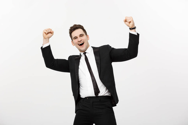 Business Concept: Portrait handsome businessman expressing surprise and joy raising his hands, isolated over white background. - Photo, Image
