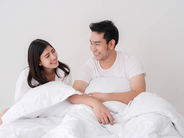 Happy Asian couple on bed and looking together. - Φωτογραφία, εικόνα