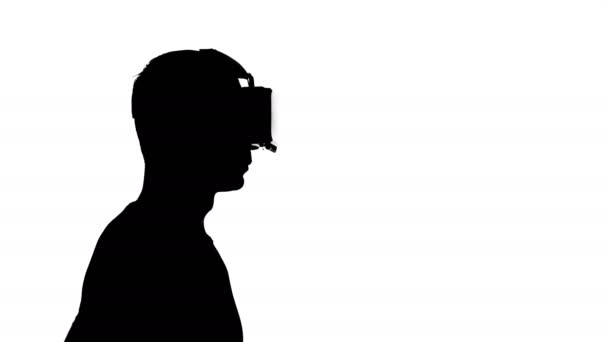 silhouette of a man in virtual reality glasses watching a video - Filmati, video