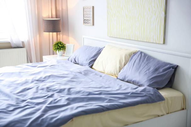 Elegant room interior with comfortable bed - Foto, imagen