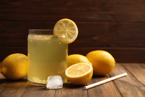 Tasty refreshing lemonade in glass on table - Foto, Bild