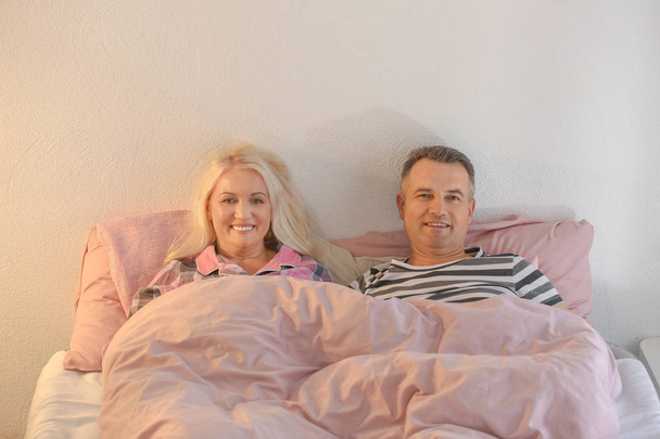 Senior couple in bed together - Фото, изображение