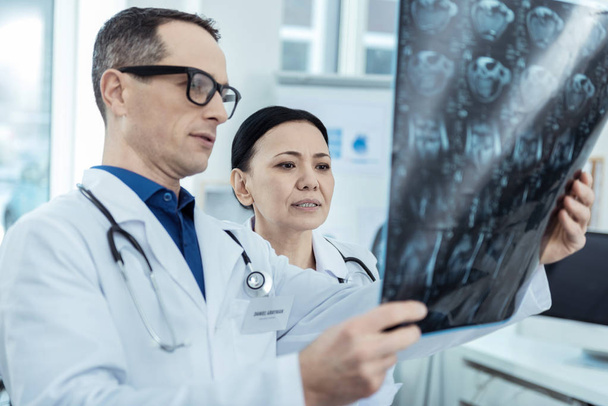 Professional radiologists holding a scan - Fotoğraf, Görsel
