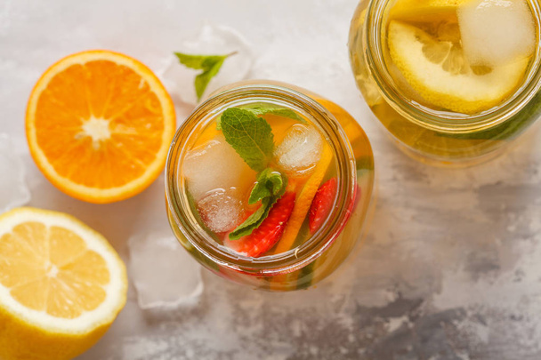 Fruit ice tea and ginger herbal ice tea with mint in a glass jar - Фото, зображення