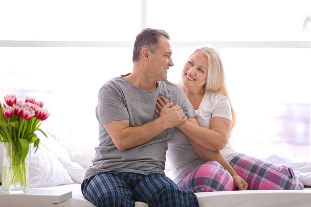 Senior couple on bed together at home - Photo, image