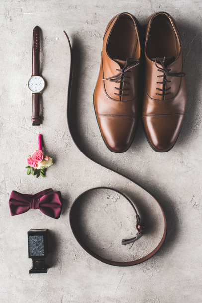 elevated view of male wedding accessories for groom on gray surface - Fotografie, Obrázek