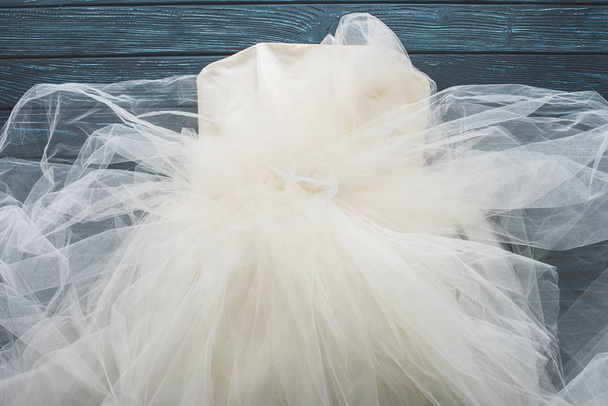 top view of wedding dress on wooden dark blue tabletop - Photo, Image