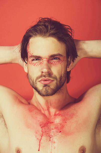 guy or man with creative fashionable makeup on red background - Valokuva, kuva