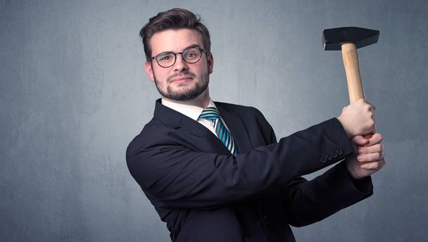 Businesman standing with tool on his hand - Foto, afbeelding