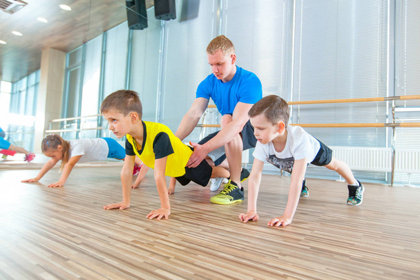 Los niños en la lección de educación física en la escuela gimnasta niño
 - Foto, imagen