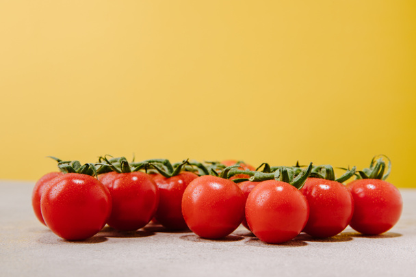 close-up shot of cherry tomatoes on yellow - Fotoğraf, Görsel