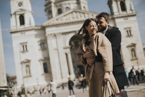 Loving couple with the St. Stephens Basilica behind them in Budapest, Hungary. - Photo, Image