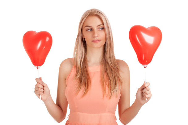 Young woman choosing one of balloons - Photo, Image