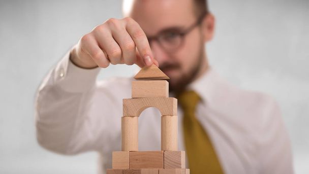 Businessman building a tower - Foto, Imagen
