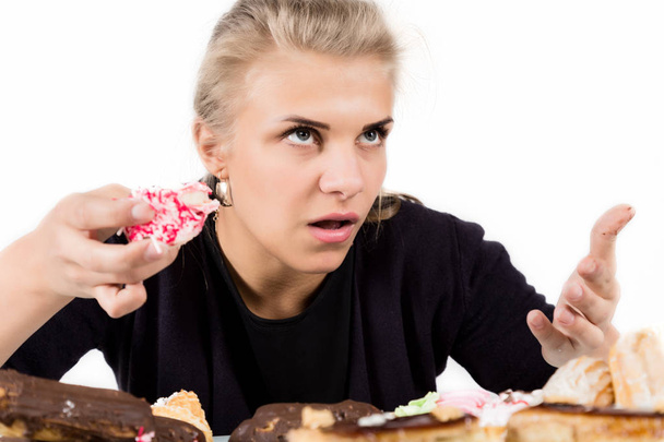 glutton woman eating cupcakes with frenzy after long diet - Foto, imagen