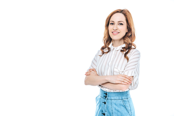 portrait of beautiful woman standing with crossed arms and smiling at camera isolated on white - Φωτογραφία, εικόνα