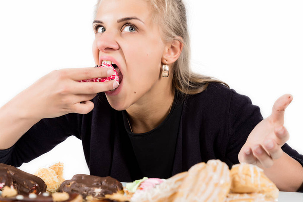 glutton woman eating cupcakes with frenzy after long diet - Fotó, kép