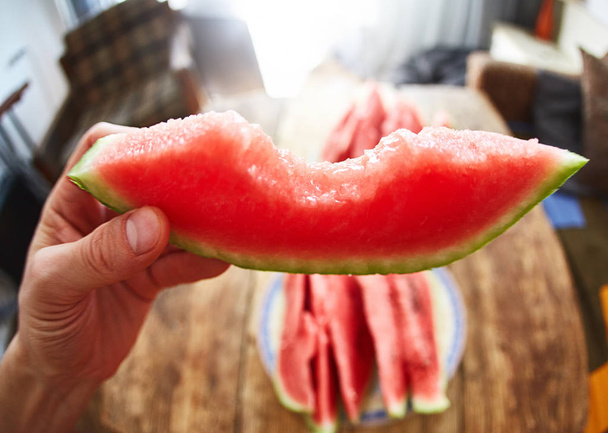 view of slice of watermelon in the hand - Fotoğraf, Görsel